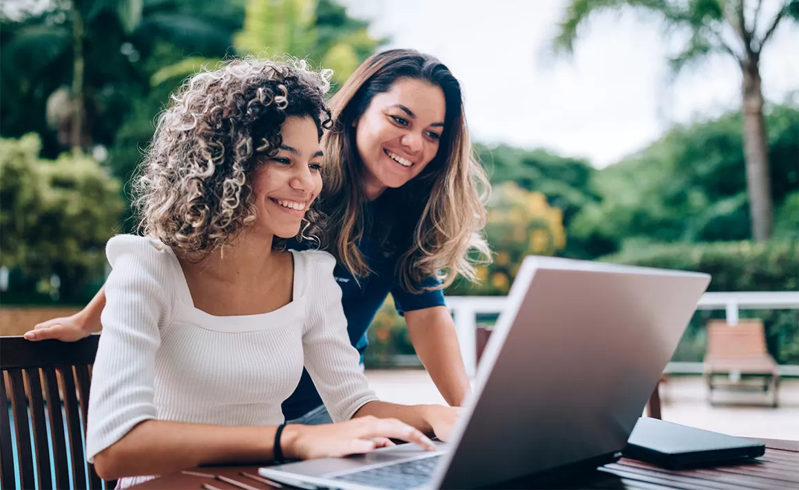 Two women looking at a laptop